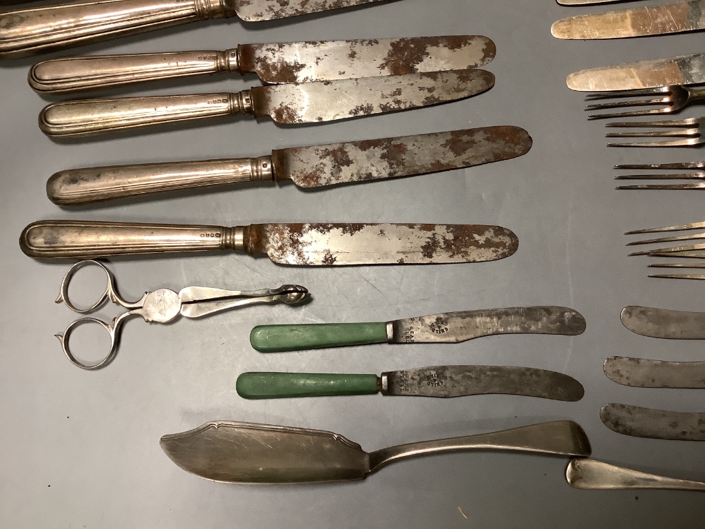 Four George IV silver handled table knives and four similar desert knives and a quantity of silver handled fruit knives and forks and two silver butter knives.